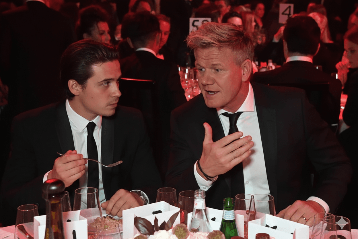 Brooklyn Beckham, wearing a black t-shirt and jeans, stands with arms crossed, looking confidently at the camera.