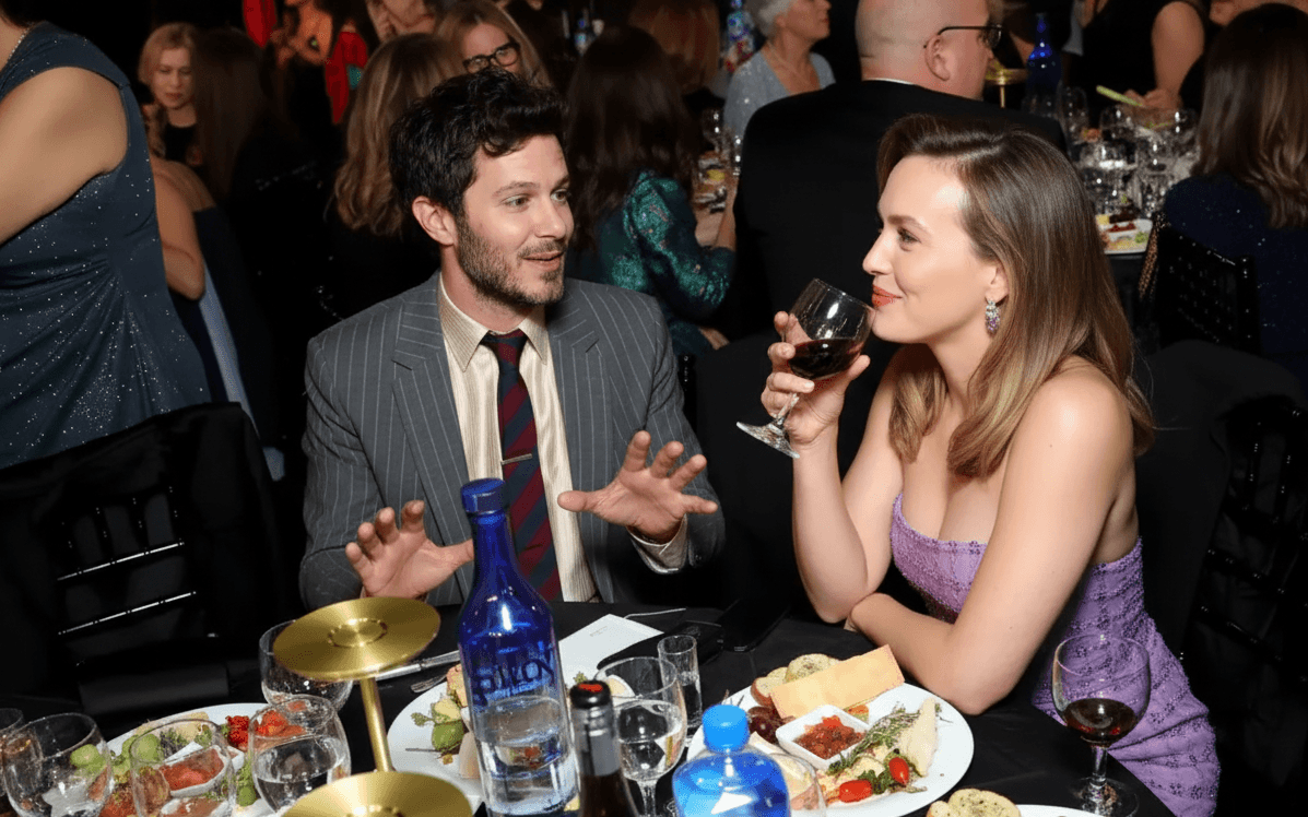 Leighton Meester and Ariana Grande smiling and talking together on the red carpet at the Critics Choice Awards.