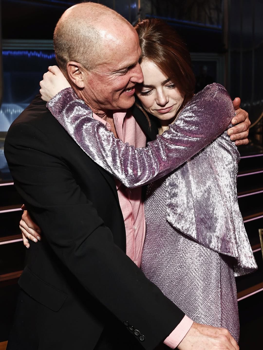 Emma Stone wearing an unconventional metallic gown with asymmetrical cutouts on the red carpet at the SAG Awards.